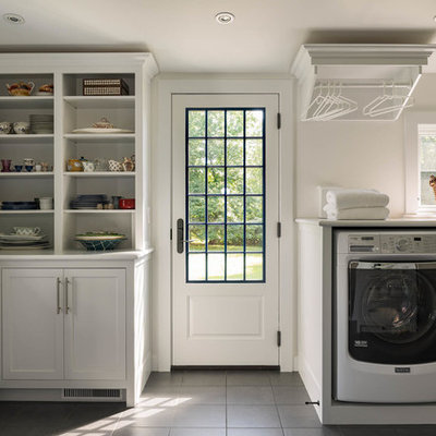 Utility room - large traditional u-shaped ceramic tile and gray floor utility room idea in Bridgeport with shaker cabinets, white cabinets, white walls and a side-by-side washer/dryer