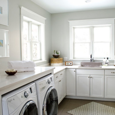 Example of a mid-sized classic l-shaped ceramic tile laundry room design in Other with a drop-in sink, shaker cabinets, white cabinets, gray walls, a side-by-side washer/dryer and white countertops