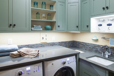 Inspiration for a mid-sized timeless l-shaped dedicated laundry room remodel in Portland Maine with an undermount sink, shaker cabinets, green cabinets, quartz countertops, a side-by-side washer/dryer and gray countertops