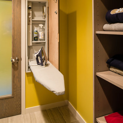 Laundry room - contemporary laundry room idea in Other with yellow walls