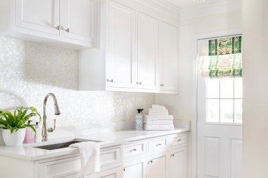 Dedicated laundry room - mid-sized transitional single-wall ceramic tile dedicated laundry room idea in Boston with white cabinets, quartz countertops, mosaic tile backsplash, white walls and white countertops