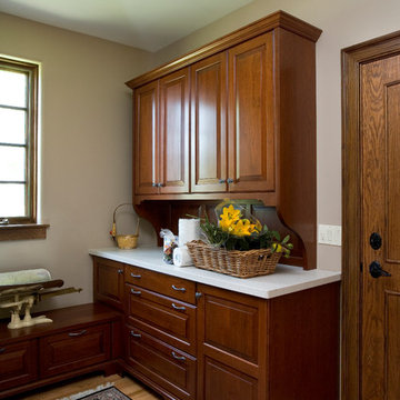 Cherry laundry room with raised panel cabinetry