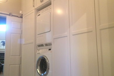Example of a mid-sized transitional laundry room design in Calgary