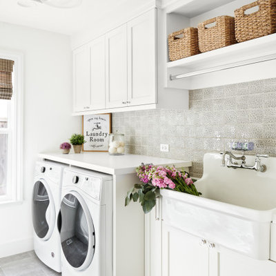 Example of a mid-sized transitional single-wall gray floor and porcelain tile dedicated laundry room design in San Francisco with an utility sink, shaker cabinets, white cabinets, white walls, a side-by-side washer/dryer, white countertops and quartzite countertops