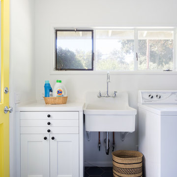Colorful Laundry Room with Custom Cabinets & Yellow Door