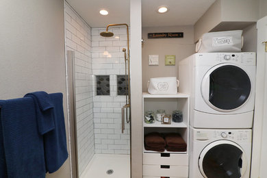 Small elegant single-wall utility room photo in Portland with a stacked washer/dryer