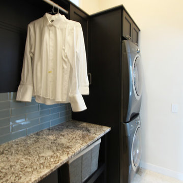 Compact Upstairs Laundry Room with Dark Stained Cabinets