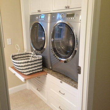 Contemporary Laundry room with raised washer dryer, white cabinets, drawer slide
