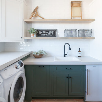 Example of a large cottage galley terra-cotta tile and orange floor dedicated laundry room design in Phoenix with a drop-in sink, shaker cabinets, green cabinets, white walls, a side-by-side washer/dryer, gray countertops and concrete countertops