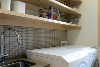 Example of a small trendy dedicated laundry room design in Other with an undermount sink, shaker cabinets, light wood cabinets, quartzite countertops, white walls and a side-by-side washer/dryer