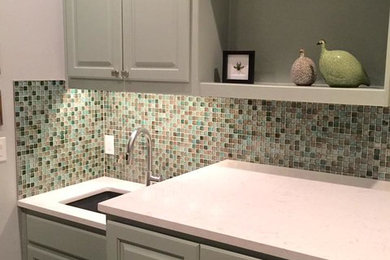 Example of a mid-sized transitional single-wall laundry room design in Austin with an undermount sink, green cabinets and gray walls