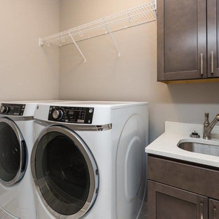 Inspiration for a mid-sized contemporary single-wall dedicated laundry room remodel in Other with an undermount sink, shaker cabinets, dark wood cabinets, quartz countertops, beige walls, a side-by-side washer/dryer and white countertops