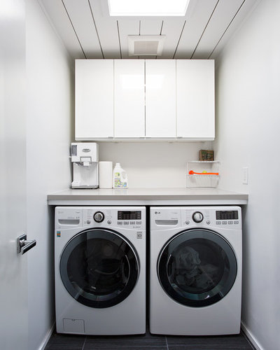 Midcentury Laundry Room by Klopf Architecture