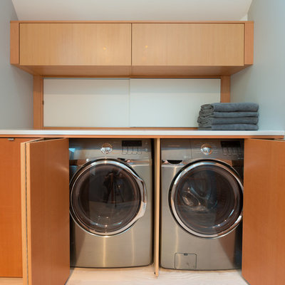 Inspiration for a contemporary laundry closet remodel in Vancouver with flat-panel cabinets, medium tone wood cabinets and a side-by-side washer/dryer
