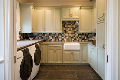Mid-sized elegant u-shaped ceramic tile utility room photo in Houston with a farmhouse sink, green cabinets and a side-by-side washer/dryer