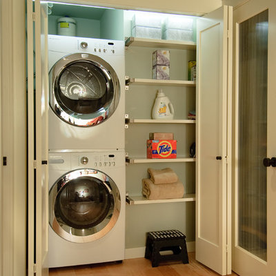 Laundry room - transitional laundry room idea in Seattle with a stacked washer/dryer