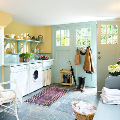 Inspiration for a farmhouse utility room remodel in Other with a farmhouse sink, open cabinets, yellow walls and a side-by-side washer/dryer