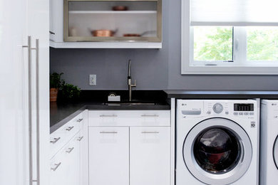 Dedicated laundry room - large modern l-shaped marble floor and white floor dedicated laundry room idea in Toronto with an undermount sink, flat-panel cabinets, white cabinets, quartz countertops, gray walls, a side-by-side washer/dryer and gray countertops