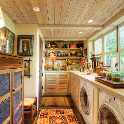 Example of a farmhouse l-shaped utility room design in Sacramento with louvered cabinets and a side-by-side washer/dryer