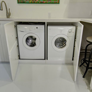 Small transitional single-wall porcelain tile and white floor laundry closet photo in Denver with an undermount sink, recessed-panel cabinets, white cabinets, quartz countertops, white walls, a side-by-side washer/dryer and gray countertops