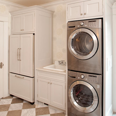 Laundry room - traditional multicolored floor laundry room idea in Minneapolis with a drop-in sink and a stacked washer/dryer