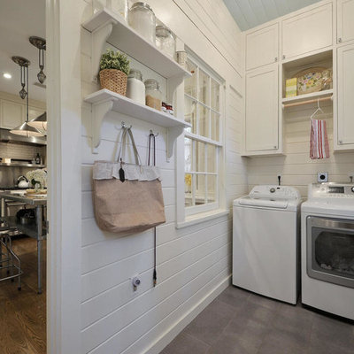 Farmhouse laundry room photo in Austin with shaker cabinets, white cabinets, white walls and a side-by-side washer/dryer