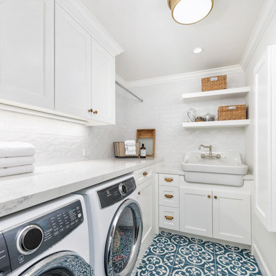 Inspiration for a small country l-shaped ceramic tile and blue floor dedicated laundry room remodel in San Francisco with a farmhouse sink, white cabinets, quartz countertops, white walls, a side-by-side washer/dryer, white countertops and shaker cabinets