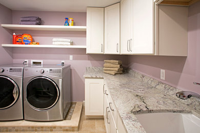 Large transitional l-shaped porcelain tile dedicated laundry room photo in Philadelphia with an undermount sink, shaker cabinets, white cabinets, granite countertops, purple walls and a side-by-side washer/dryer