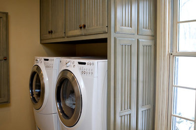 Example of a country laundry room design in Chicago with green cabinets, a side-by-side washer/dryer and recessed-panel cabinets