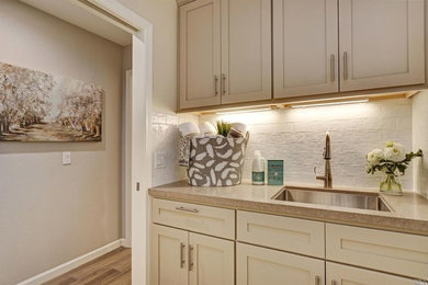 Inspiration for a timeless laundry room remodel in San Francisco with shaker cabinets, beige cabinets, quartz countertops and beige walls