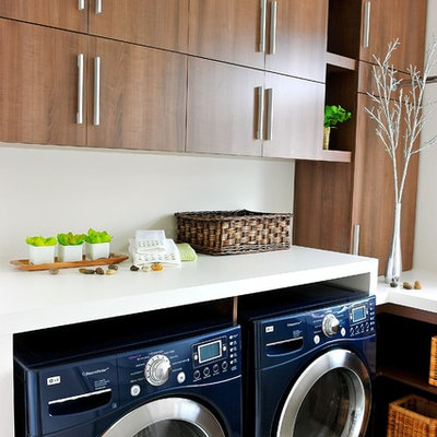Trendy laundry room photo in Montreal with flat-panel cabinets, medium tone wood cabinets and a side-by-side washer/dryer