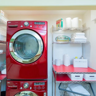 Inspiration for a small mid-century modern laundry closet remodel in Detroit with a stacked washer/dryer