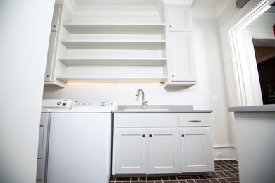Medium sized modern galley separated utility room in Other with a built-in sink, recessed-panel cabinets, white cabinets, composite countertops, grey walls, porcelain flooring, a side by side washer and dryer, brown floors and grey worktops.