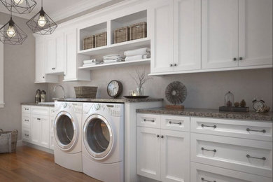 Example of a huge transitional single-wall medium tone wood floor and brown floor utility room design in Philadelphia with a drop-in sink, shaker cabinets, white cabinets, laminate countertops, gray walls, a side-by-side washer/dryer and multicolored countertops
