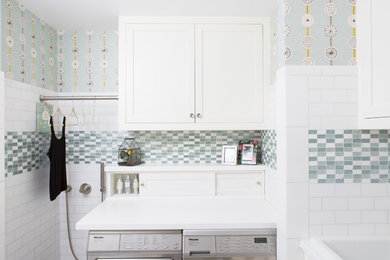 Idéer för att renovera en funkis tvättstuga enbart för tvätt, med vita skåp, blå väggar och en tvättmaskin och torktumlare bredvid varandra