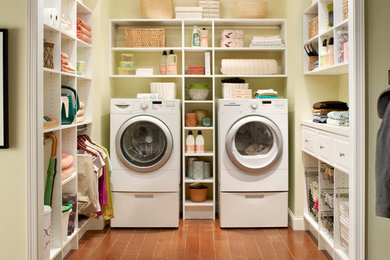 Example of a mid-sized classic u-shaped dark wood floor utility room design in Boston with open cabinets, white cabinets, solid surface countertops, a side-by-side washer/dryer and beige walls