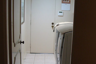 Example of a small single-wall dedicated laundry room design in San Diego with a side-by-side washer/dryer