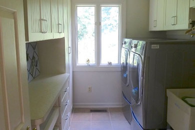 Laundry room - mid-sized traditional galley laundry room idea in Other with an utility sink, beaded inset cabinets, beige cabinets, laminate countertops and a side-by-side washer/dryer