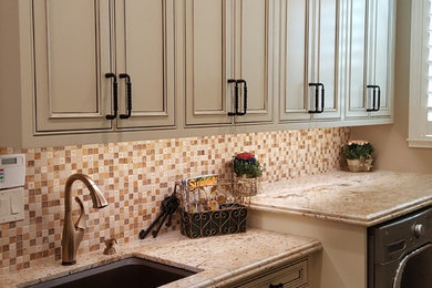 Example of a mid-sized classic galley medium tone wood floor laundry room design in Other with an undermount sink, beaded inset cabinets, white cabinets, granite countertops, beige walls and a side-by-side washer/dryer