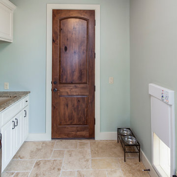 Laundry room with electronic dog door- 2014 Parade Home in Willie Nelson's Tierr