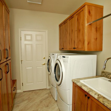 Laundry room with new cabinets, bench and storage.