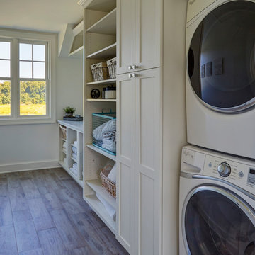 Laundry Room with Stacked Washer/Dryer and Open Shelving