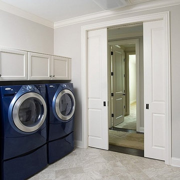 Laundry Room with Two Sets of Washers and Dryers and Flat Panel Cabinetry