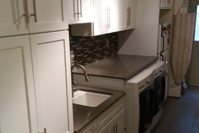 Utility room - mid-sized transitional single-wall porcelain tile and gray floor utility room idea in Detroit with an utility sink, shaker cabinets, white cabinets, quartz countertops, white walls and a side-by-side washer/dryer