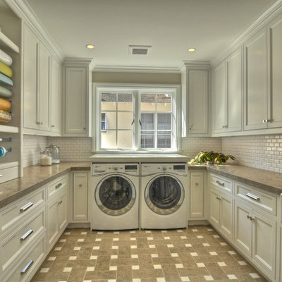 Example of a classic laundry room design in Orange County with a farmhouse sink and white cabinets