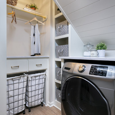 Dedicated laundry room - cottage medium tone wood floor and brown floor dedicated laundry room idea in Kansas City with open cabinets, white cabinets, white walls and white countertops