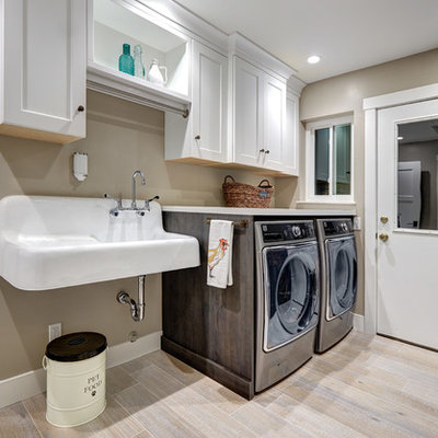 Example of a mid-sized cottage porcelain tile and beige floor laundry room design in Sacramento with an utility sink, recessed-panel cabinets, white cabinets, quartz countertops, beige walls and a side-by-side washer/dryer