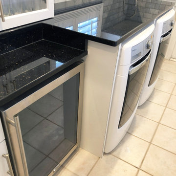 Marble Laundry room with built in front loading machines