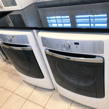 Marble Laundry room with built in front loading machines