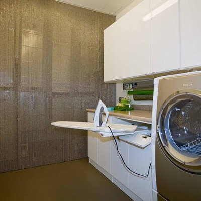 Inspiration for a mid-sized contemporary galley utility room remodel in Portland with flat-panel cabinets, white cabinets, a side-by-side washer/dryer and gray walls
